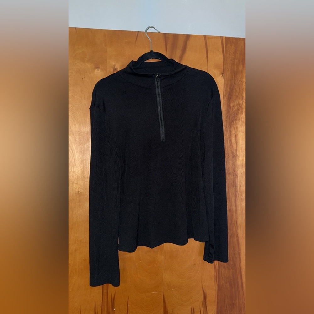 A black turtle neck zipper shirt. The material is very breathable and thin